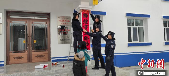 圖為恩和哈達(dá)邊境派出所民警貼對聯(lián)?！《骱凸_(dá)邊境派出所供圖